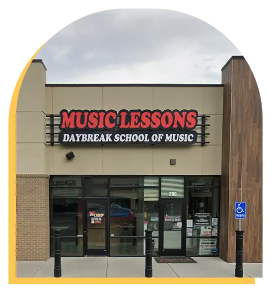 Storefront of Daybreak School of Music with a large sign reading Music Lessons above the entrance. Glass doors and windows are visible, along with a handicap parking sign—your destination for top-rated music lessons Tampa.